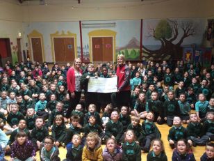 Oakgrove present a cheque to the Red Cross